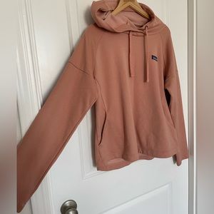 Peach colored lightweight hoodie.